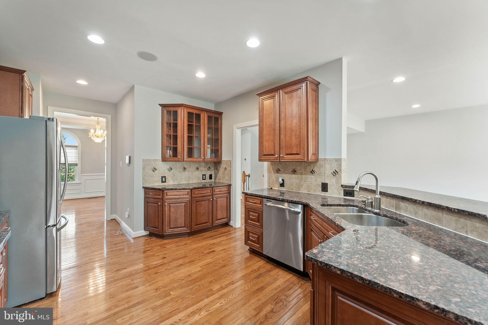 42524 Rowderbury Square Chantilly, VA 20152 - Photo 41 of 73 a kitchen with a sink stove top oven and refrigerator