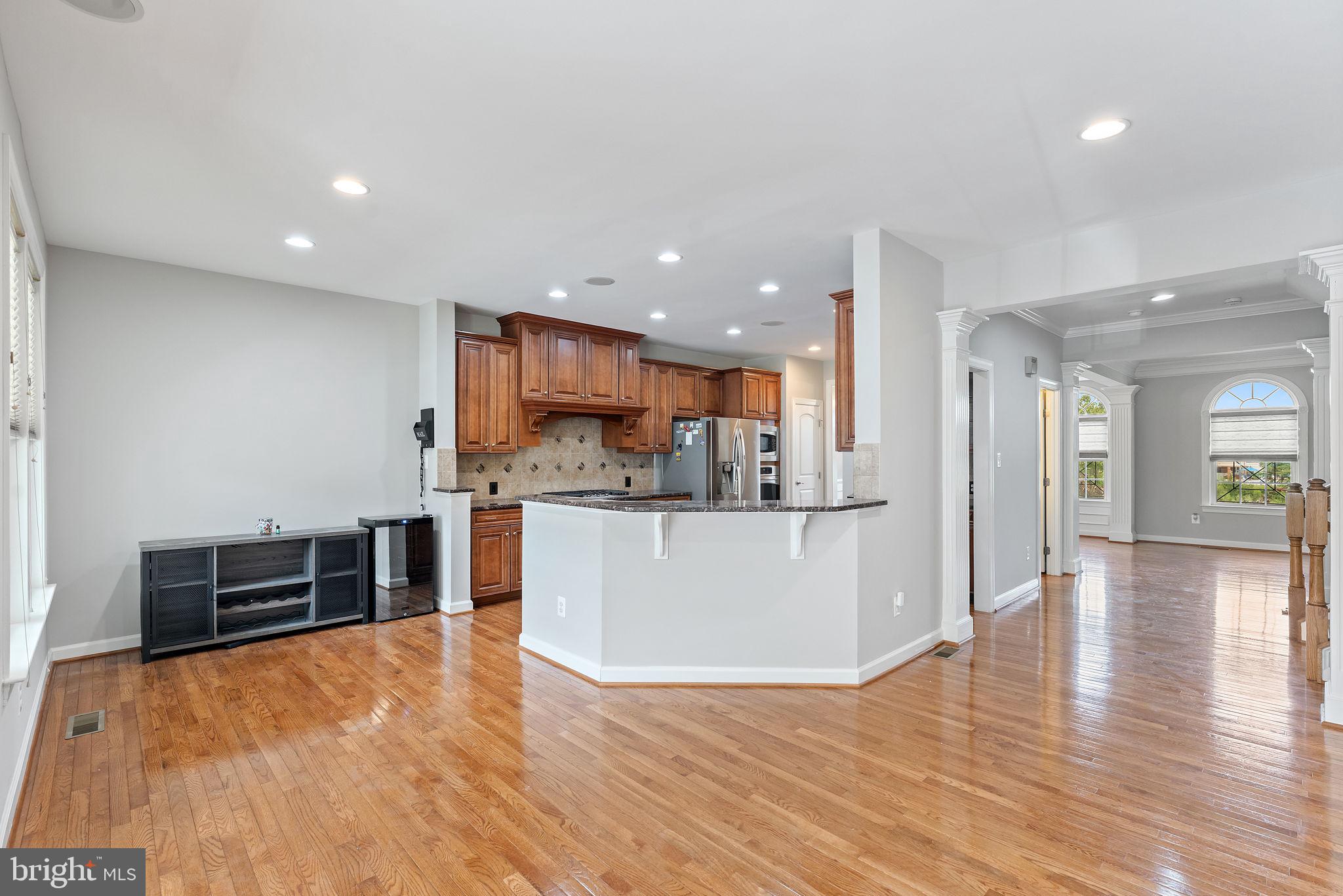42524 Rowderbury Square Chantilly, VA 20152 - Photo 43 of 73 a view of a kitchen with kitchen island wooden floor center island and stainless steel appliances