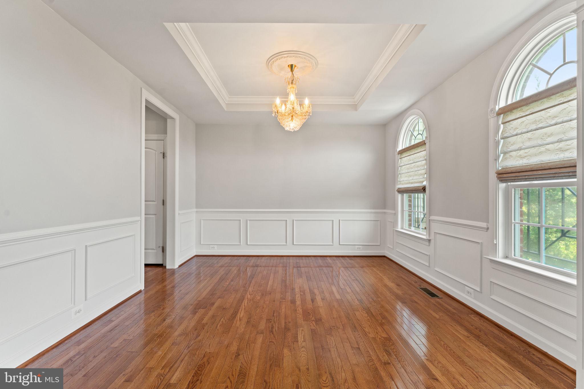 42524 Rowderbury Square Chantilly, VA 20152 - Photo 5 of 73 a view of an empty room with wooden floor and a window