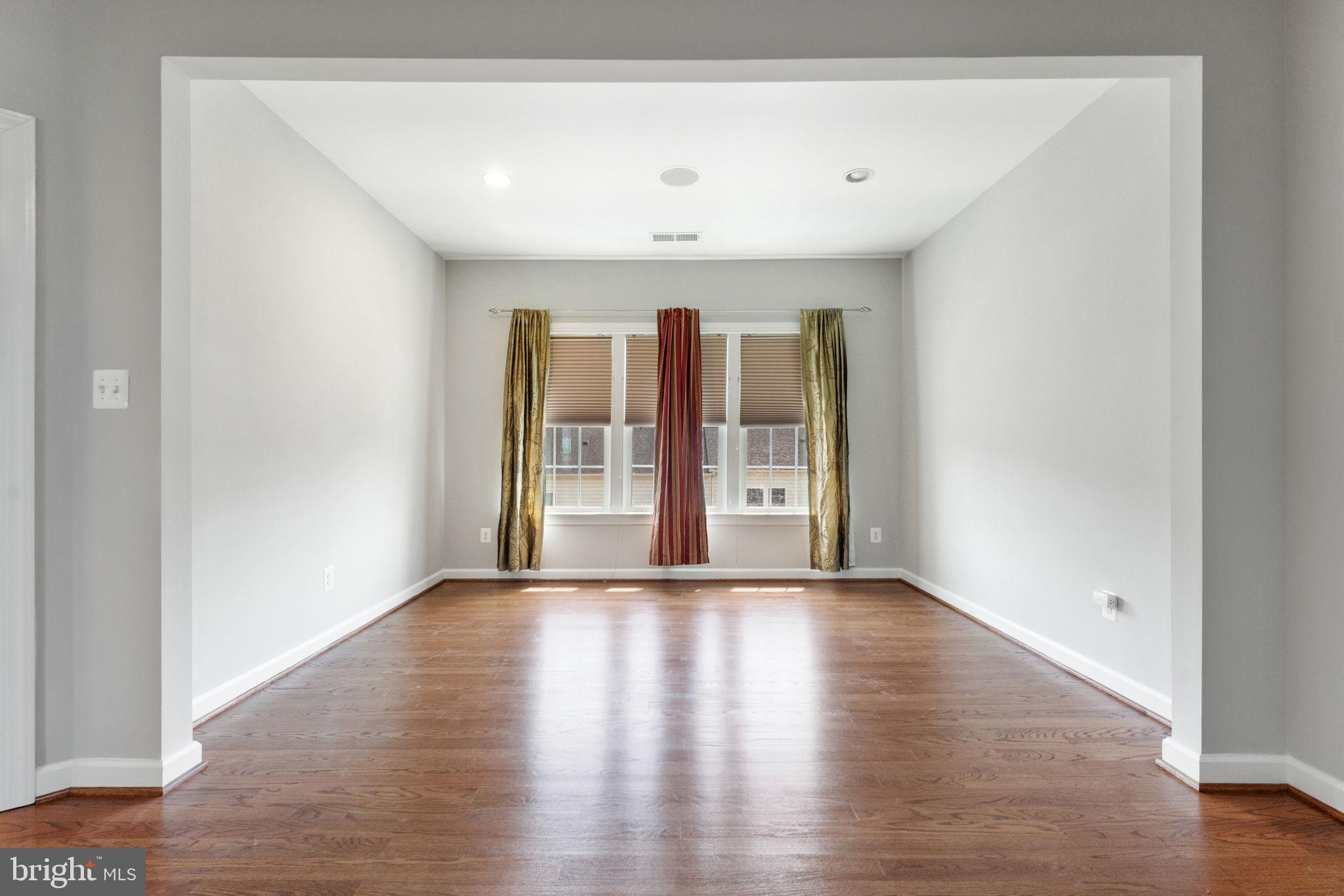 42524 Rowderbury Square Chantilly, VA 20152 - Photo 52 of 73 a view of an empty room with wooden floor and a window