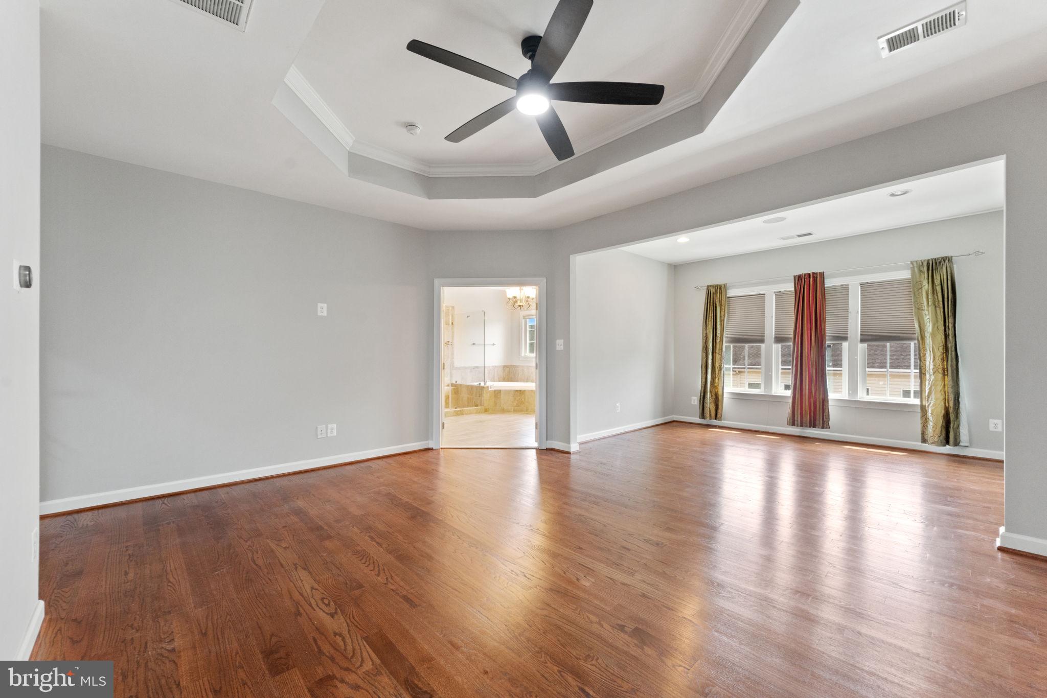 42524 Rowderbury Square Chantilly, VA 20152 - Photo 9 of 73 a view of an empty room with window and wooden floor