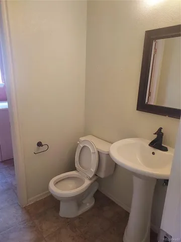 a white toilet sitting next to a bathroom sink