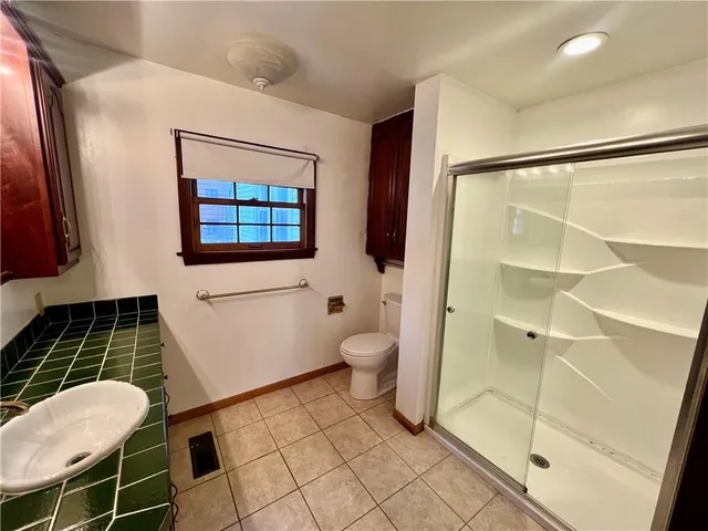 a bathroom with a toilet and a shower