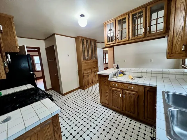 a kitchen with stainless steel appliances a sink stove and refrigerator