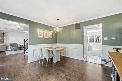 a view of a room with wooden floor and furniture