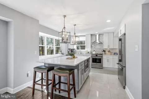 a kitchen with a sink stove and white cabinets