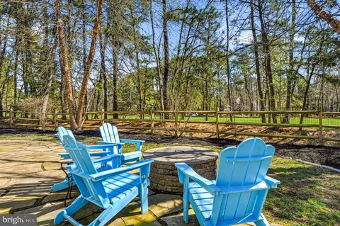 a view of backyard with seating space and trees