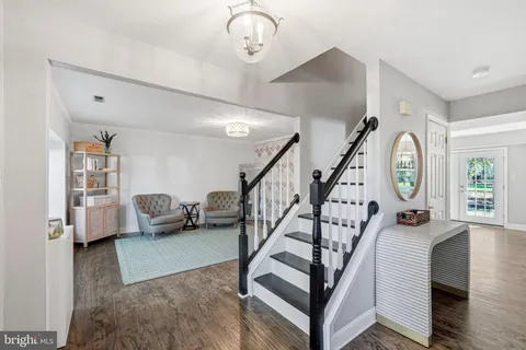 a view of entryway livingroom and hall with wooden floor