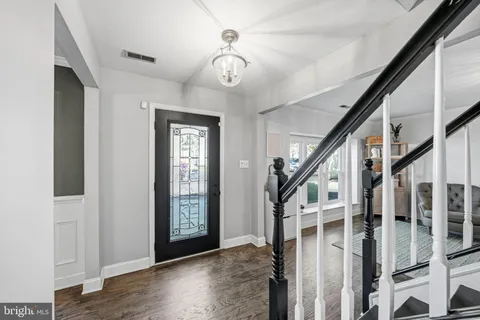 a view of an entryway with wooden floor and stairs