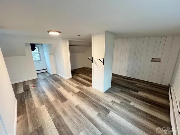 a view of an empty room and wooden floor