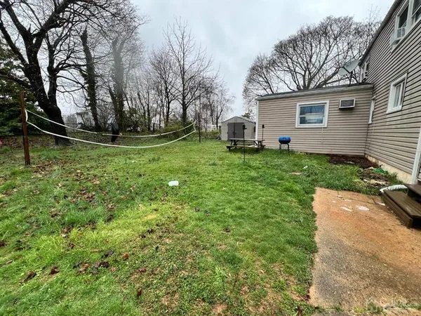 a view of backyard with a garden and trees
