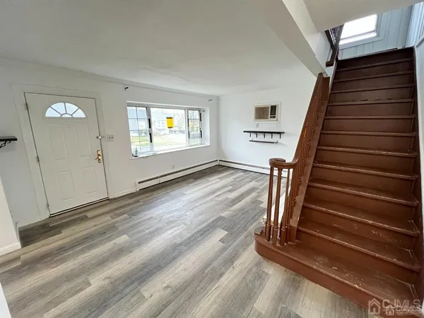 a view of an entryway with wooden floor