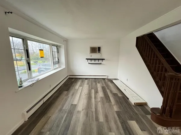 a view of a hallway with wooden floor and stairs
