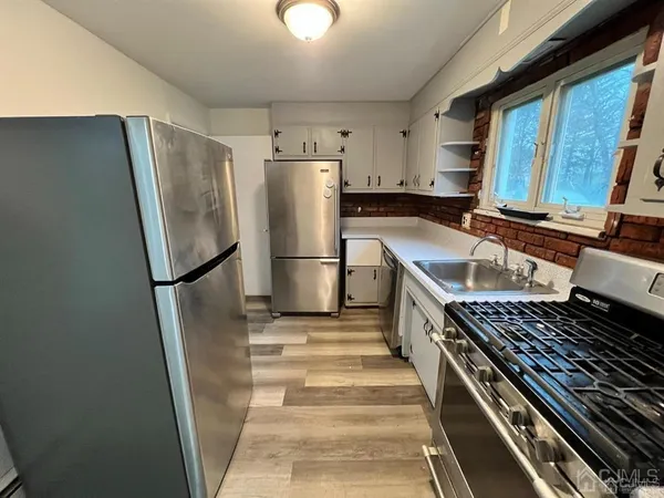 a kitchen with stainless steel appliances a refrigerator and a sink