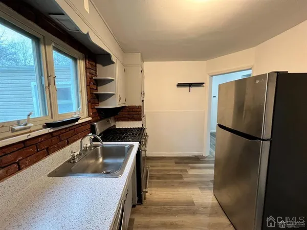 a kitchen with a refrigerator and a sink