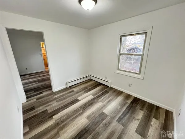 a view of an empty room and wooden floor