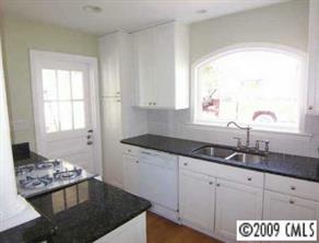 143 McAlway Road Charlotte, NC 28211 - Photo 6 of 8 a kitchen with granite countertop a sink and white cabinets