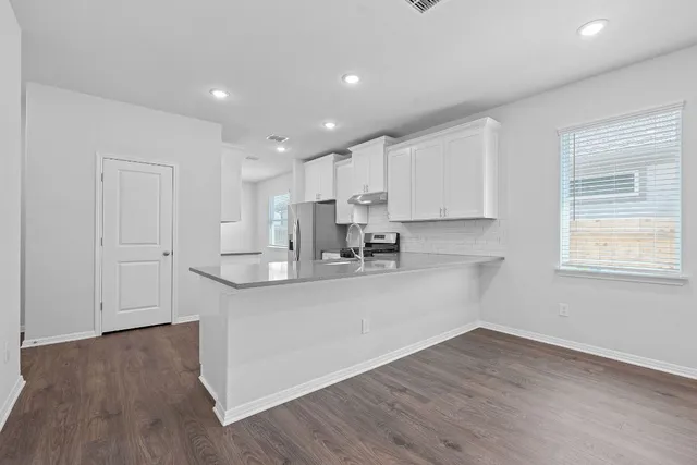 a view of kitchen with wooden floor