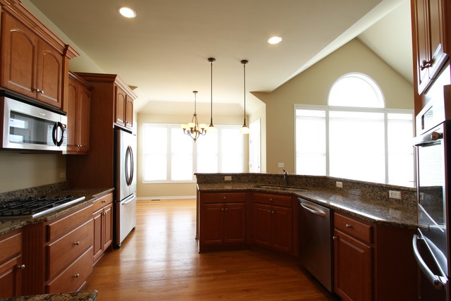 792 Ridgeview Lane Sugar Grove, IL 60554 - Photo 13 of 29 a kitchen with stainless steel appliances granite countertop a sink a stove and a wooden floors