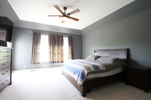 792 Ridgeview Lane Sugar Grove, IL 60554 - Photo 19 of 29 a spacious bedroom with a large bed and a chandelier