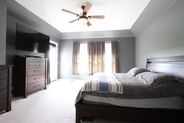 792 Ridgeview Lane Sugar Grove, IL 60554 - Photo 20 of 29 a bedroom with a bed a flat tv screen and a chandelier