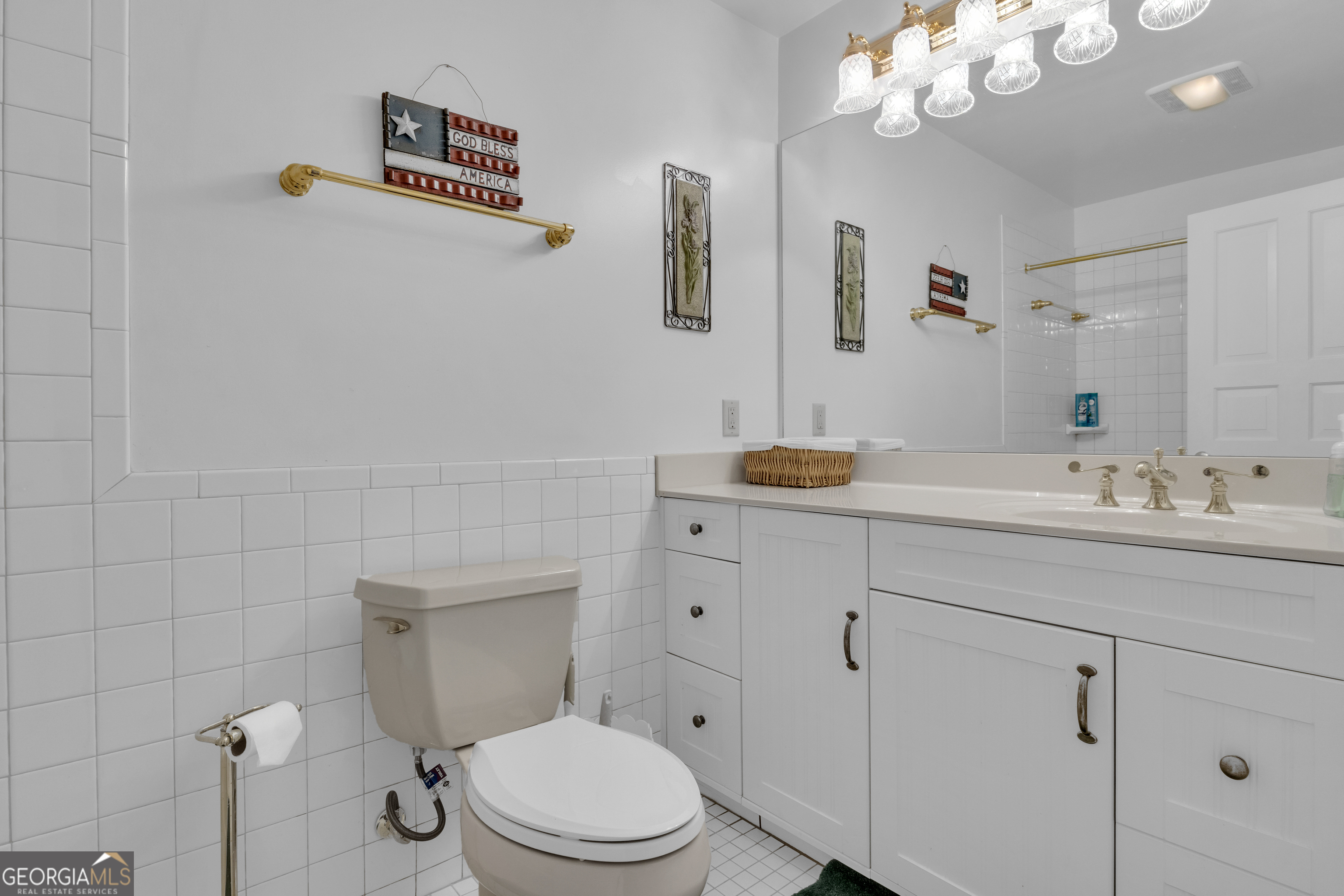 14803 Woolsey Road Hampton, GA 30228 - Photo 107 of 142 a bathroom with a toilet a sink a mirror and vanity