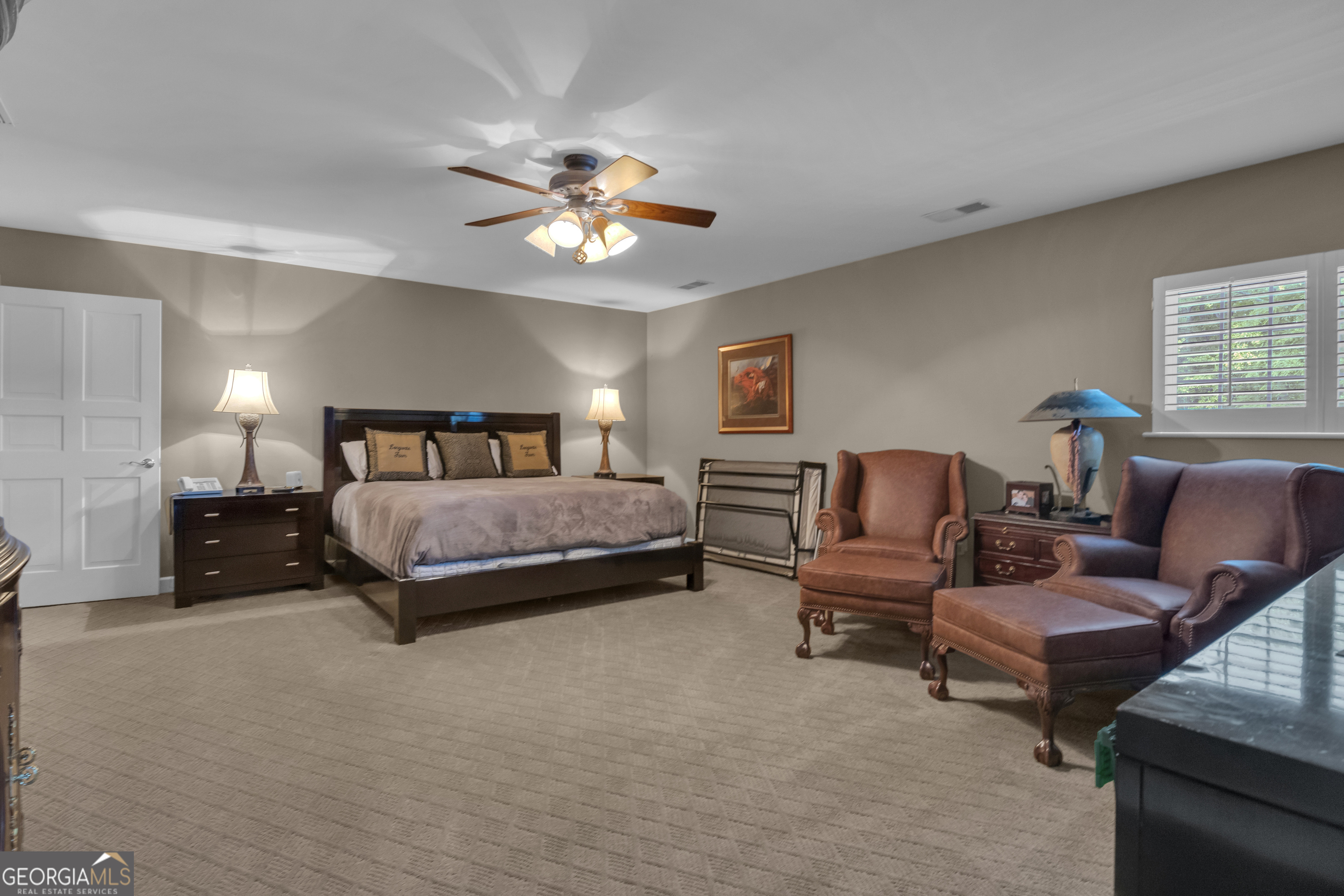 14803 Woolsey Road Hampton, GA 30228 - Photo 110 of 142 a spacious bedroom with a bed and a couch