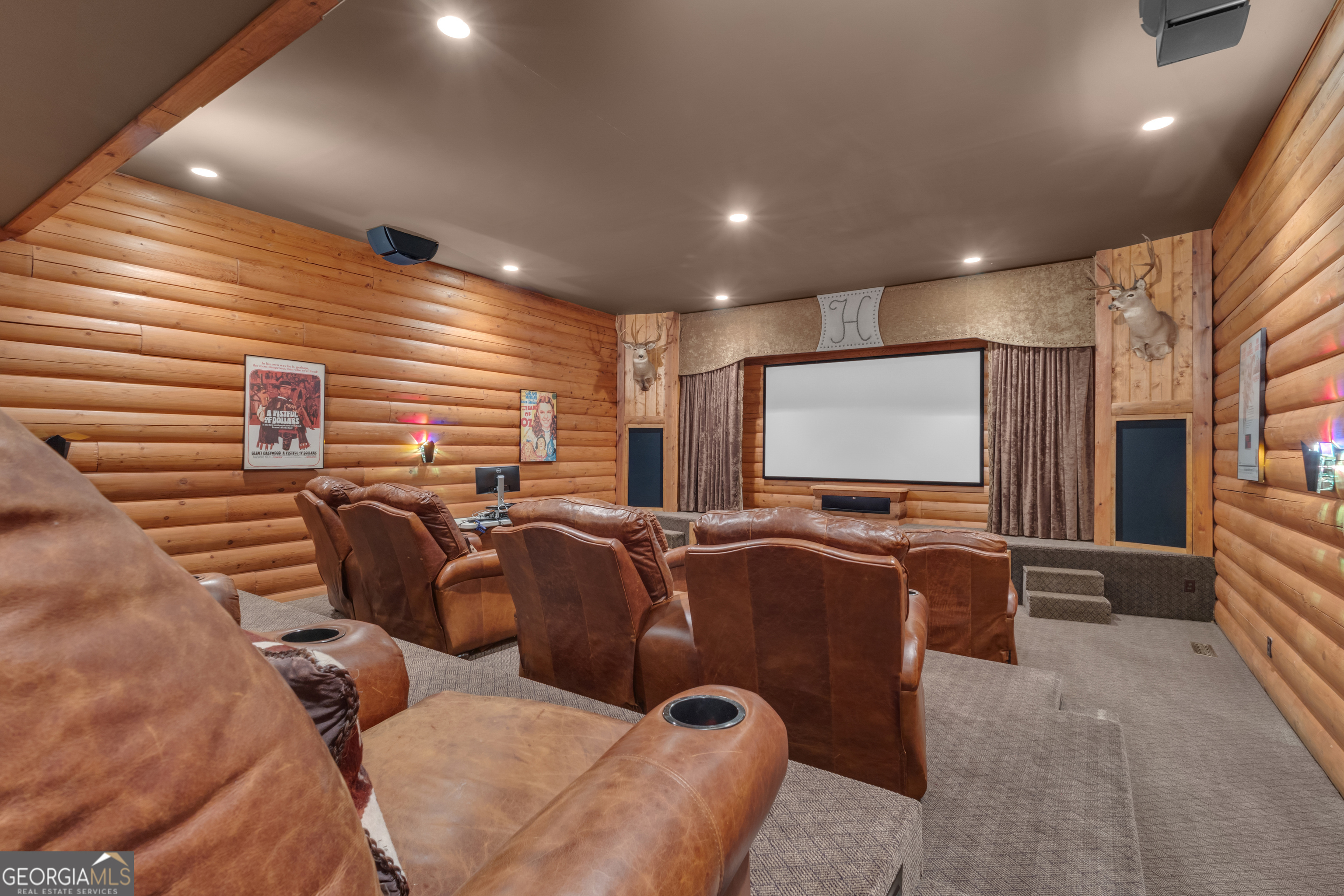14803 Woolsey Road Hampton, GA 30228 - Photo 33 of 142 a media room with lots of chairs and a projector screen