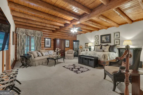 a spacious bedroom with a bed and a couch