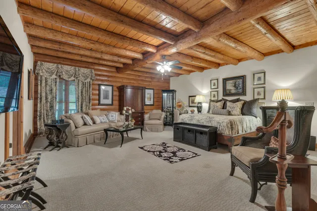 a spacious bedroom with a bed and a couch