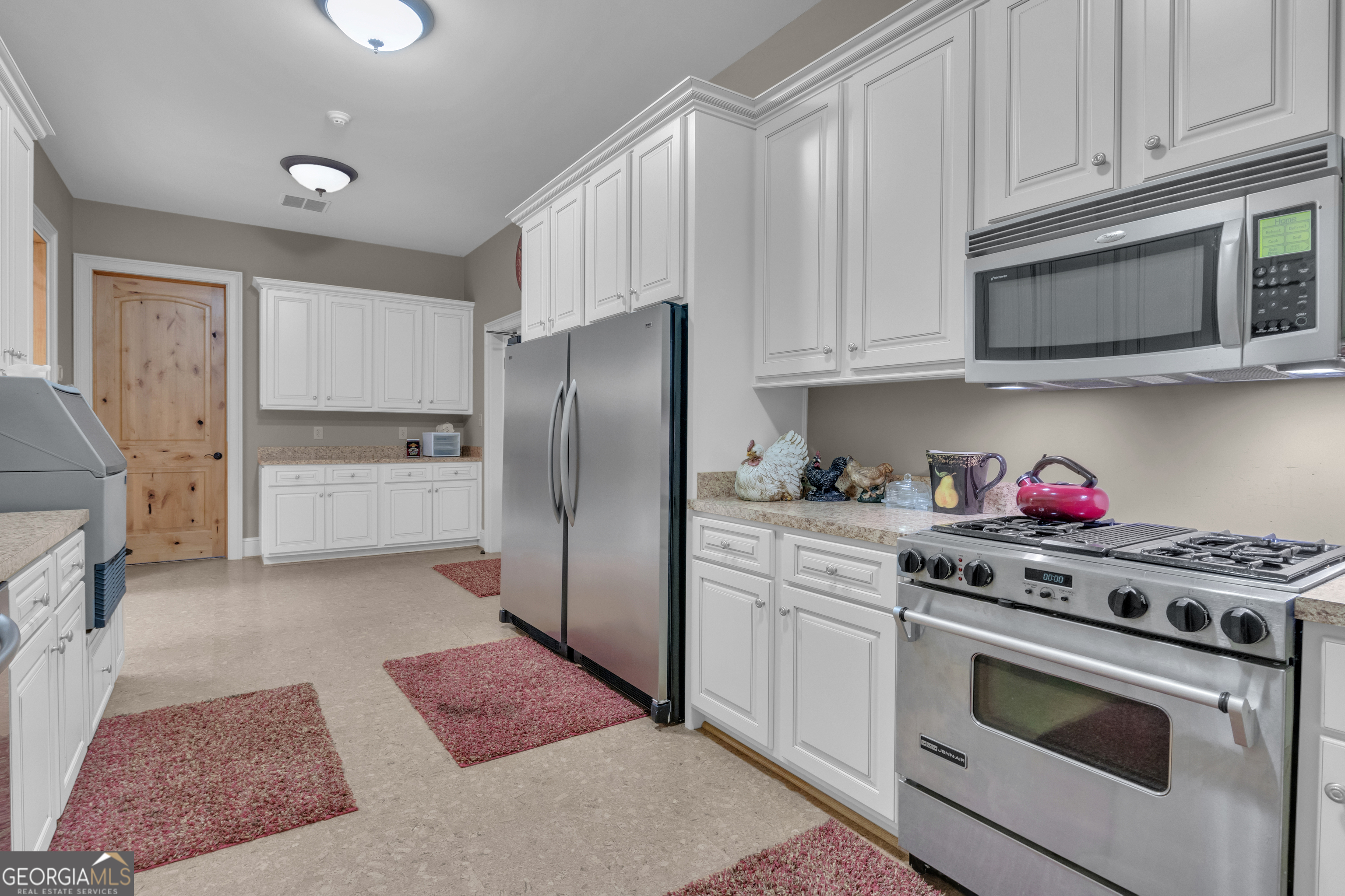 14803 Woolsey Road Hampton, GA 30228 - Photo 90 of 142 a kitchen with stainless steel appliances granite countertop a refrigerator stove and white cabinets