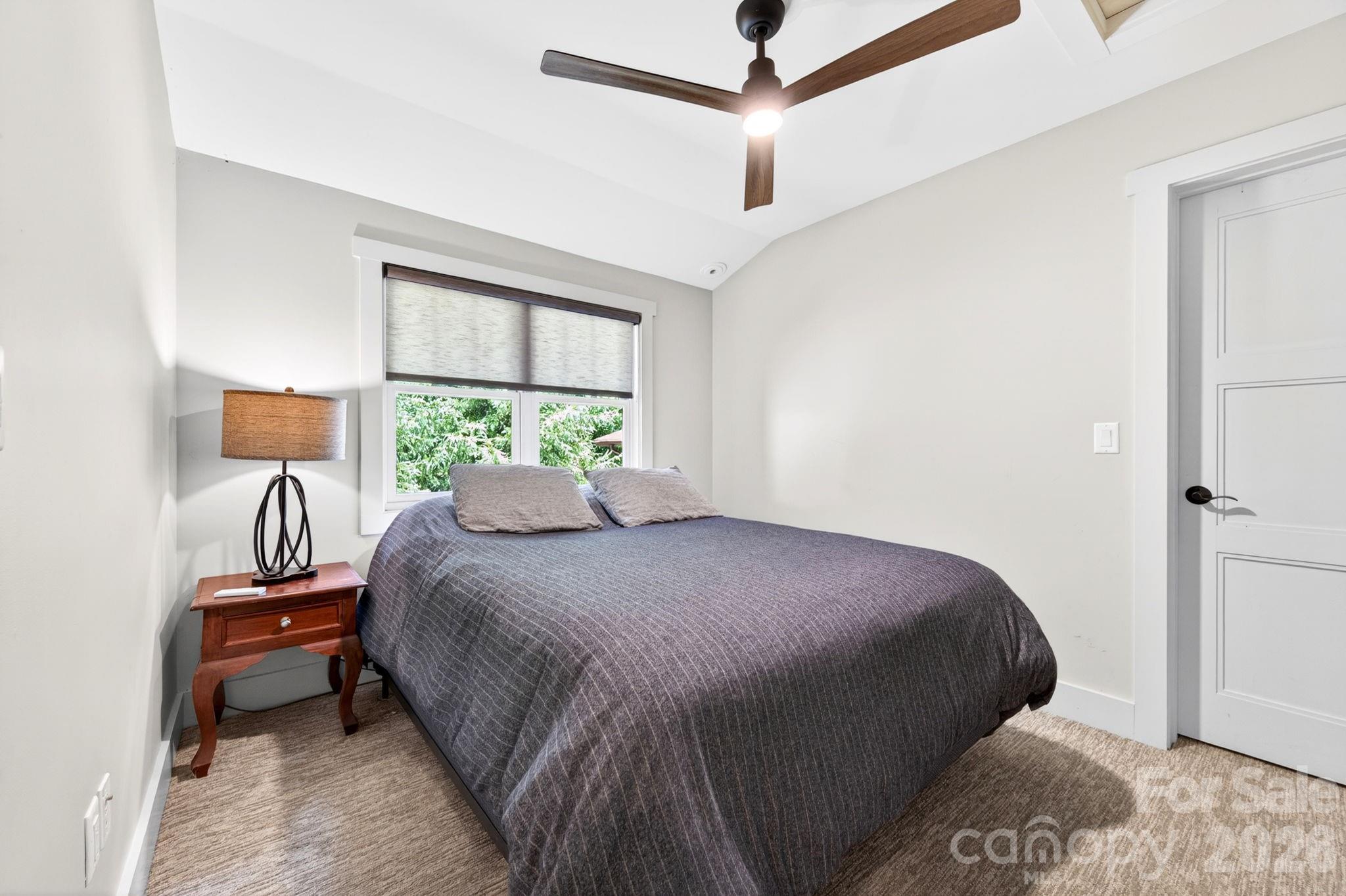 235 Bull Creek Road Asheville, NC 28805 - Photo 20 of 47 a bedroom with a bed and a window