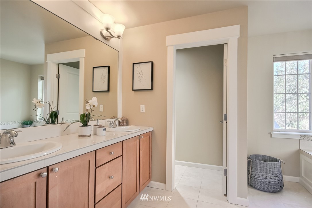 21809 38th Drive Southeast Bothell, WA 98021 - Photo 17 of 27 a bathroom with a sink a vanity and a mirror