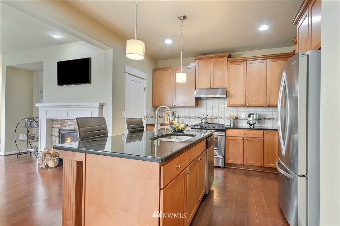 21809 38th Drive Southeast Bothell, WA 98021 - Photo 9 of 27 a kitchen with stainless steel appliances granite countertop a sink stove and refrigerator
