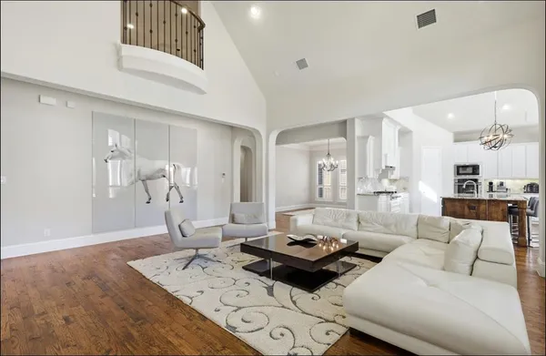 a living room with furniture and wooden floor