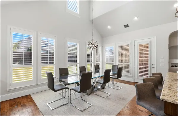 a living room with furniture and floor to ceiling windows