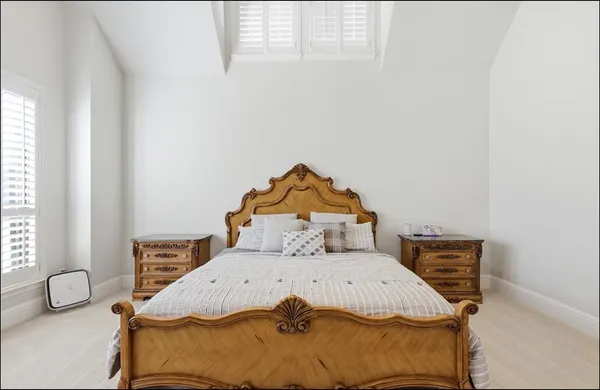 a bedroom with a bed and a window