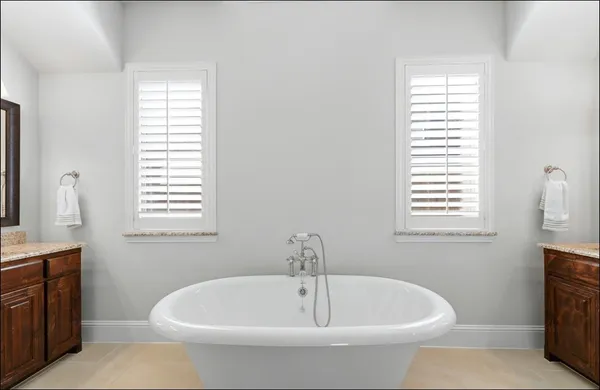 a white bath tub sitting next to a window
