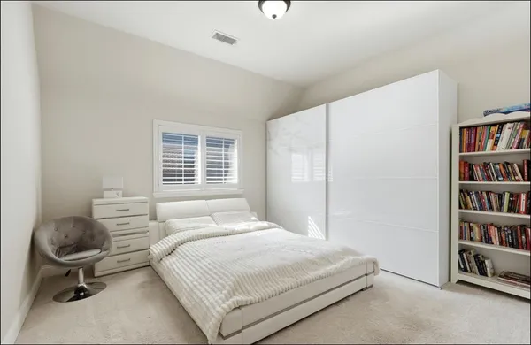 a bedroom with a bed and a book shelf