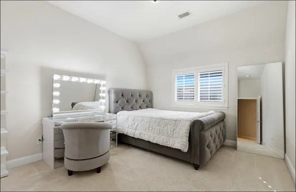 a bedroom with a bed and a table