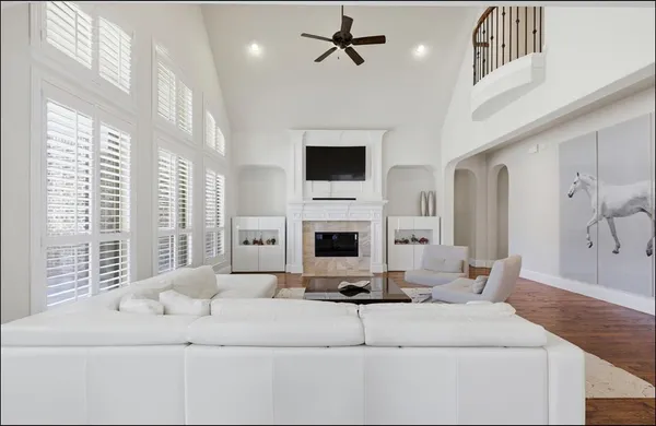 a living room with furniture a fireplace and a flat screen tv