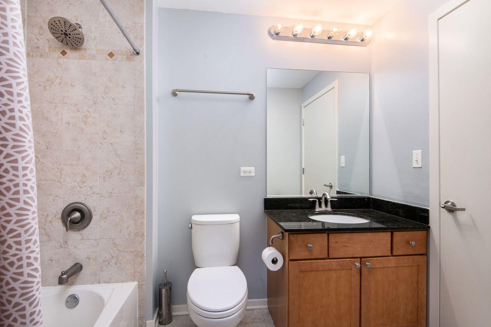 520 South State Street, Unit 808 Chicago, IL 60605 - Photo 14 of 23 a bathroom with a granite countertop bathtub sink vanity mirror and toilet