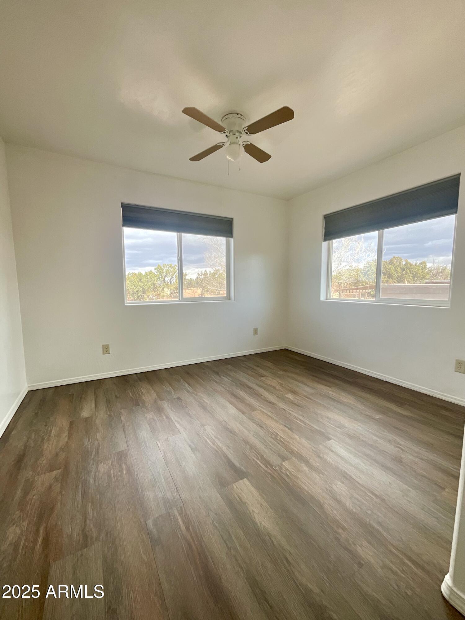 242 County Road Concho, AZ 85924 - Photo 12 of 63 a view of an empty room with wooden floor and a window