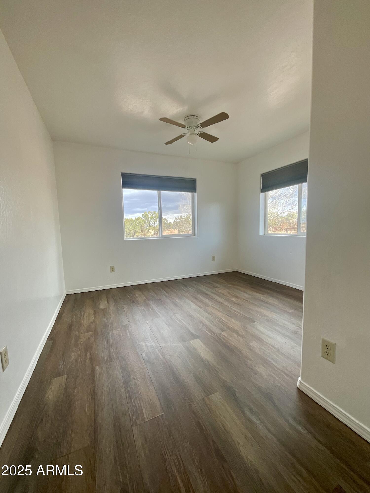 242 County Road Concho, AZ 85924 - Photo 13 of 63 an empty room with wooden floor and windows