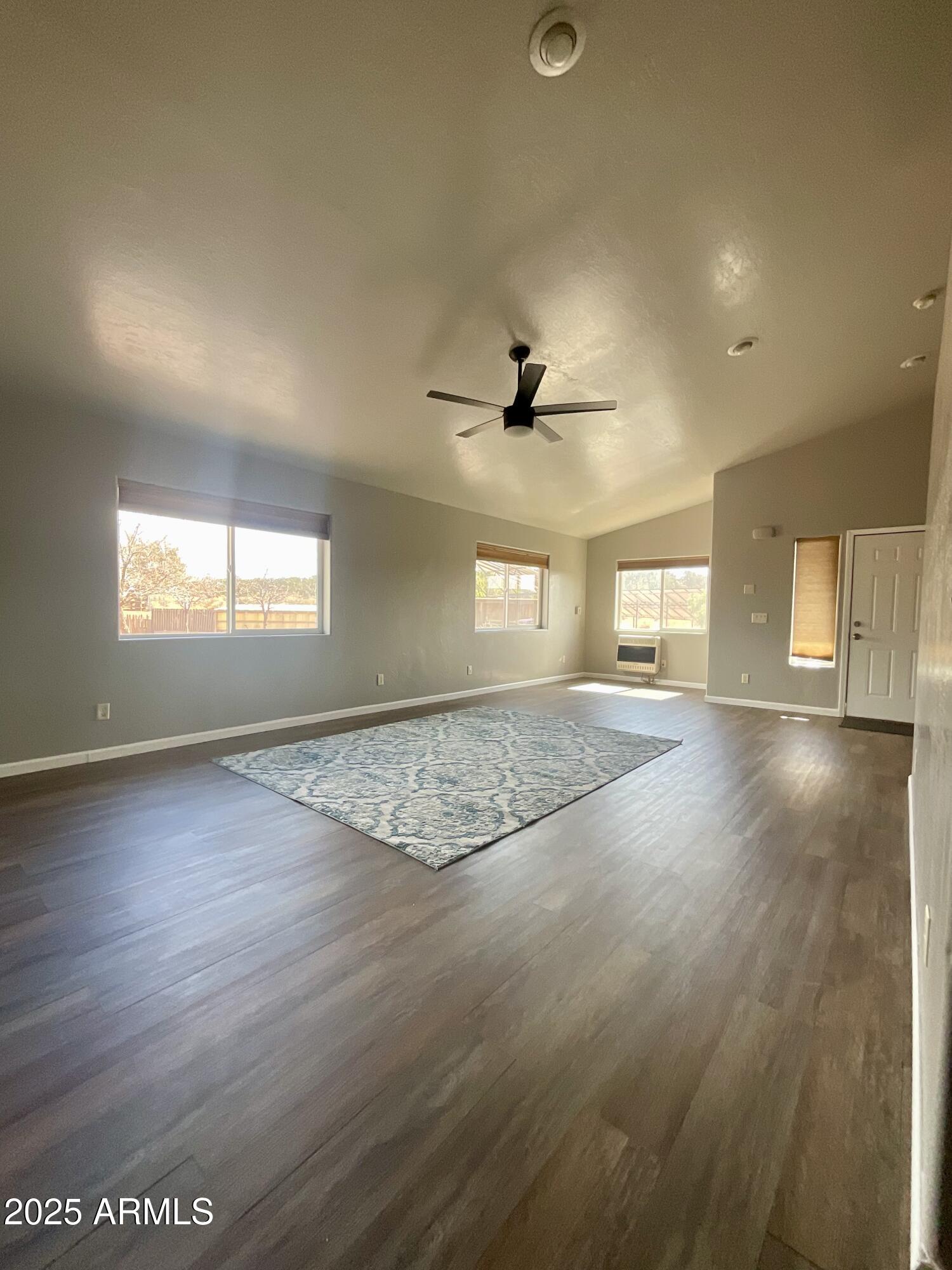 242 County Road Concho, AZ 85924 - Photo 14 of 63 an empty room with wooden floor and windows