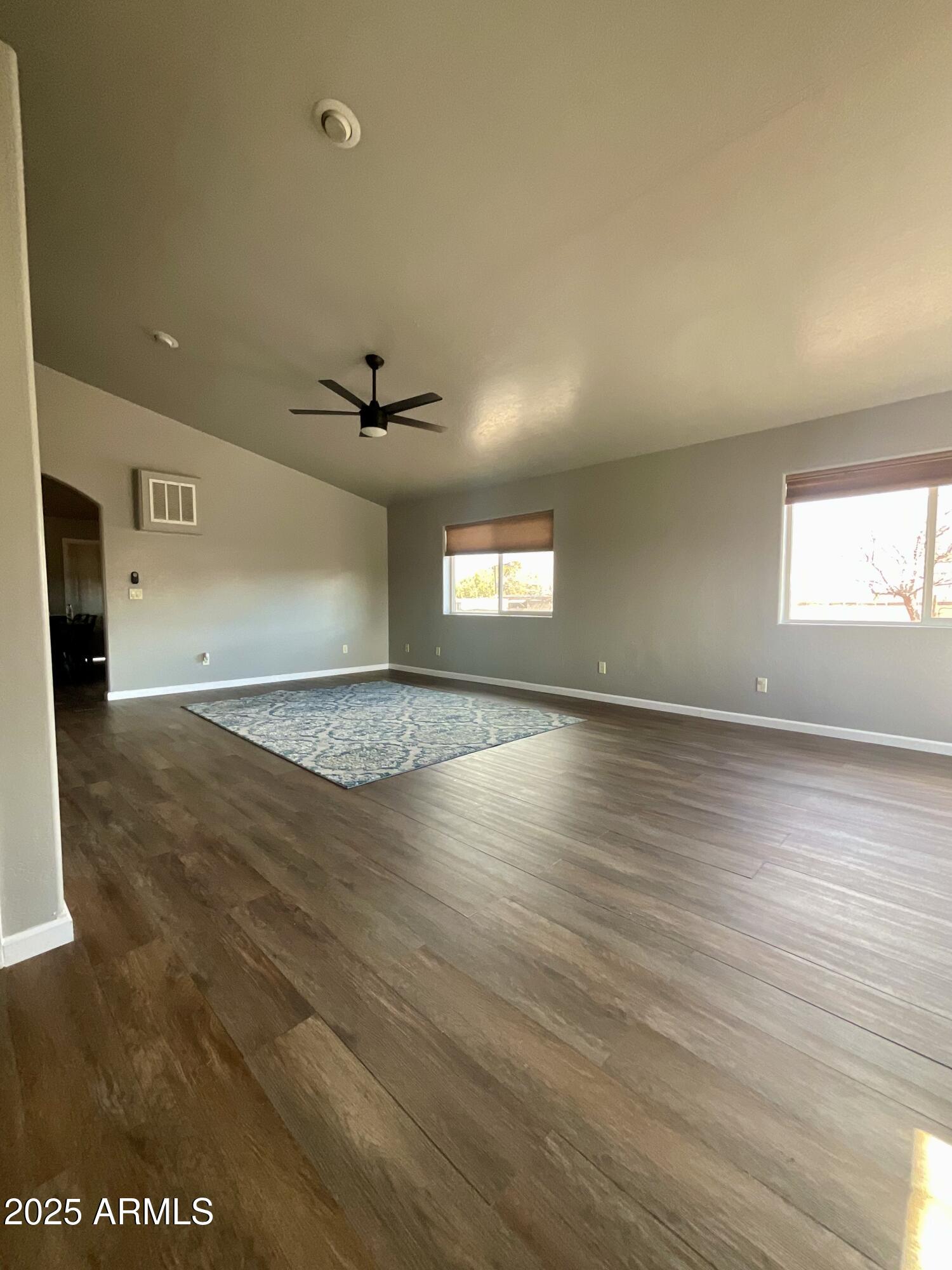 242 County Road Concho, AZ 85924 - Photo 17 of 63 an empty room with wooden floor and windows