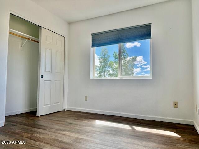 242 County Road Concho, AZ 85924 - Photo 9 of 63 a view of an empty room with wooden floor and a window