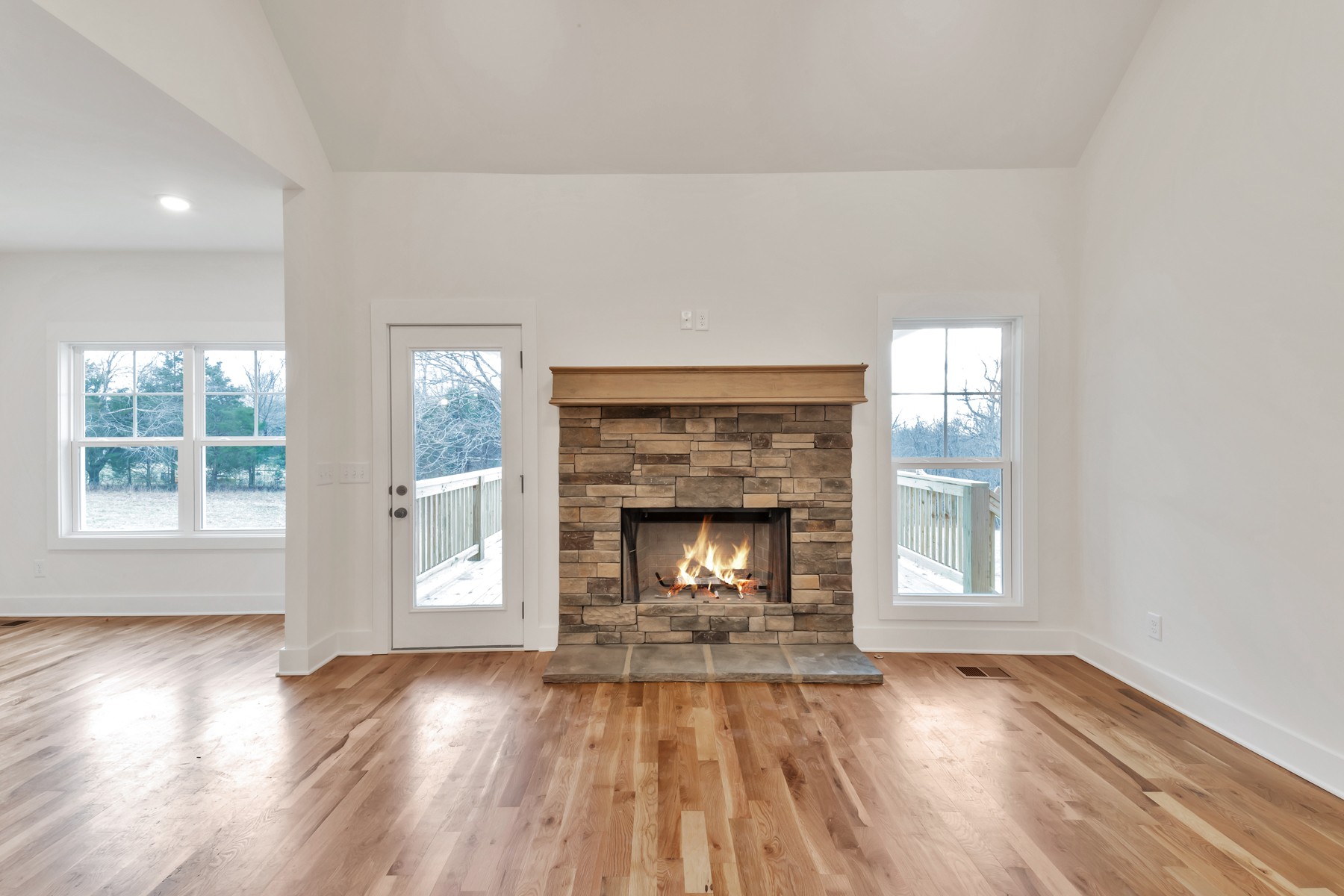 3184 Battle Creek Road Springfield, TN 37172 - Photo 3 of 15 an empty room with wooden floor fireplace and windows