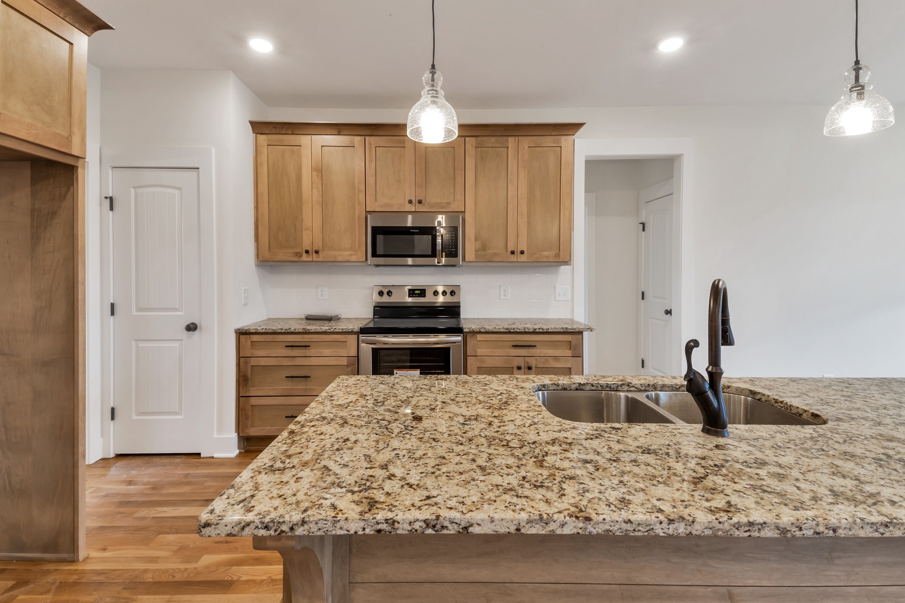 3184 Battle Creek Road Springfield, TN 37172 - Photo 5 of 15 a kitchen with stainless steel appliances kitchen island granite countertop a stove and a sink