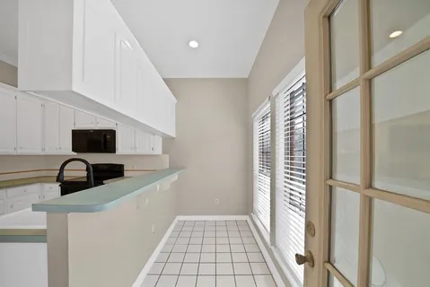 a kitchen with a sink and a refrigerator